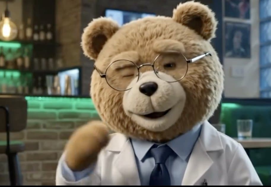 Close-up of Ted the bear waving hello